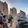 Guests using a guide rope to hike across a steep cliffside trail